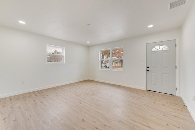 entryway with light hardwood / wood-style flooring and a healthy amount of sunlight