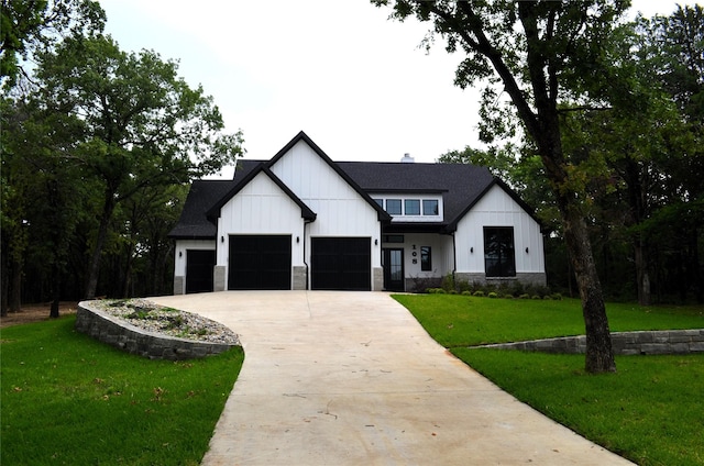 modern farmhouse style home featuring a front lawn and a garage