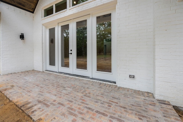 property entrance featuring a patio area and french doors