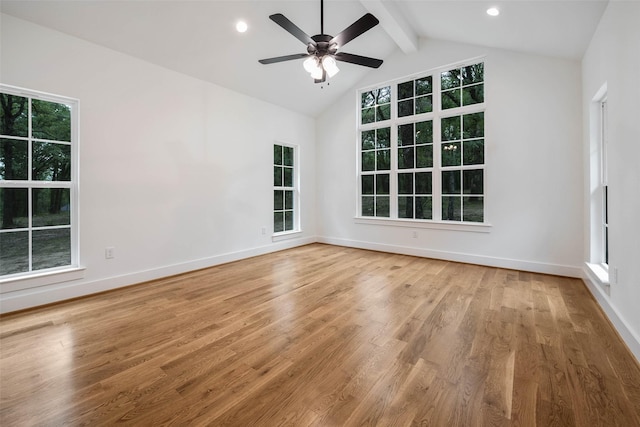 unfurnished room with vaulted ceiling with beams, ceiling fan, wood-type flooring, and a healthy amount of sunlight