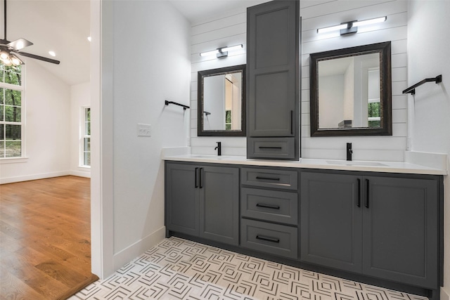 bathroom featuring hardwood / wood-style flooring, ceiling fan, lofted ceiling, and vanity