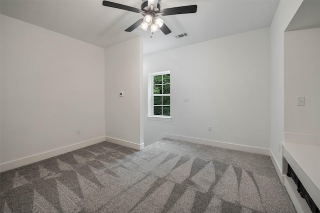 empty room featuring carpet floors and ceiling fan