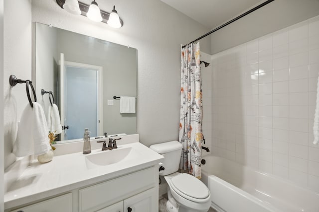 full bathroom with vanity, shower / tub combo, and toilet