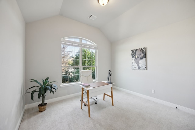 office space featuring light carpet and vaulted ceiling