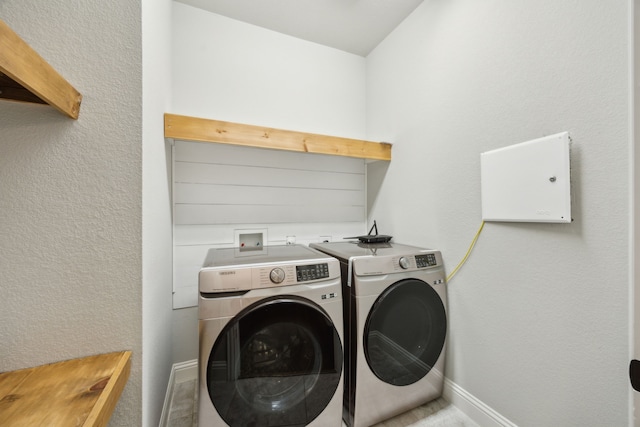 clothes washing area featuring washer and clothes dryer