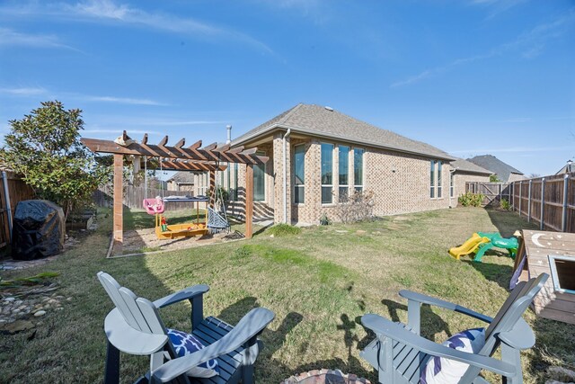 rear view of property featuring a lawn and a pergola