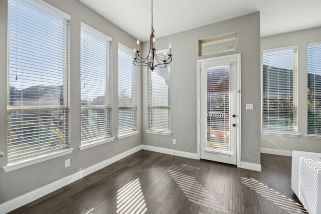 unfurnished dining area featuring a wealth of natural light and an inviting chandelier