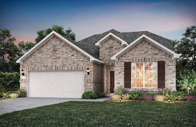 view of front of home with a yard and a garage