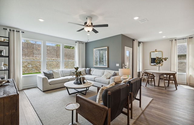 living room with ceiling fan and light hardwood / wood-style flooring