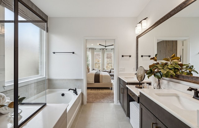 bathroom featuring a tub, tile patterned flooring, and vanity