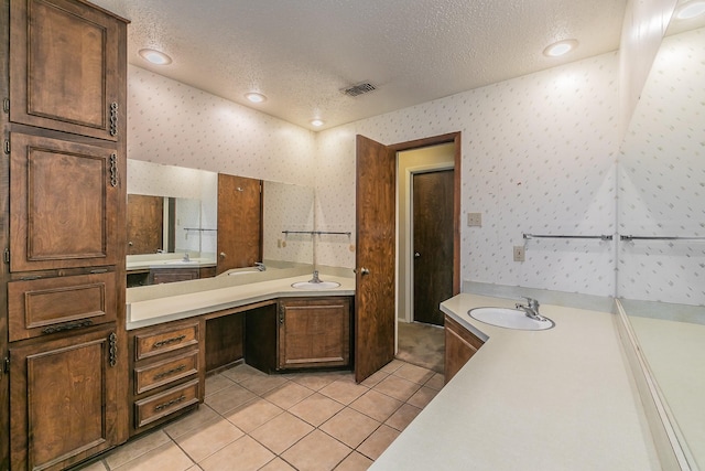 bathroom with vanity, tile patterned floors, and a textured ceiling