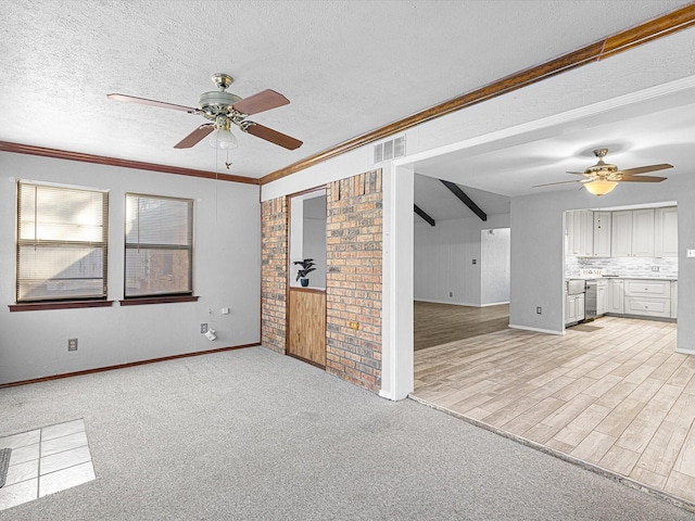 unfurnished living room with light carpet, a textured ceiling, ceiling fan, and ornamental molding