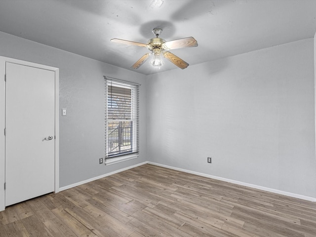 empty room featuring ceiling fan and light hardwood / wood-style flooring