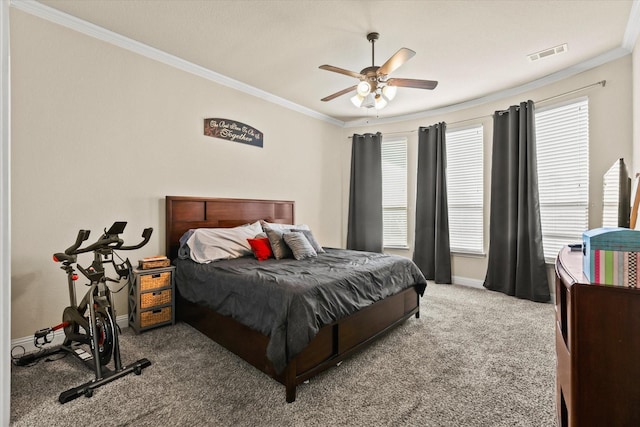 carpeted bedroom featuring ceiling fan and crown molding