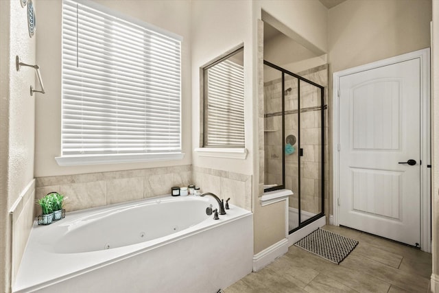 bathroom with tile patterned floors and plus walk in shower