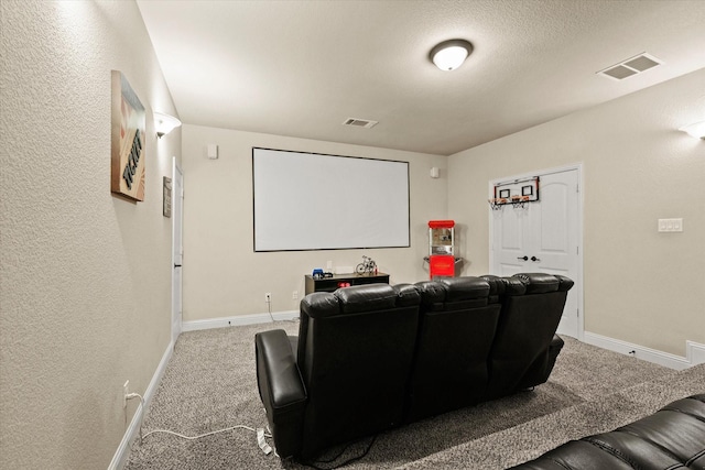 carpeted cinema featuring a textured ceiling