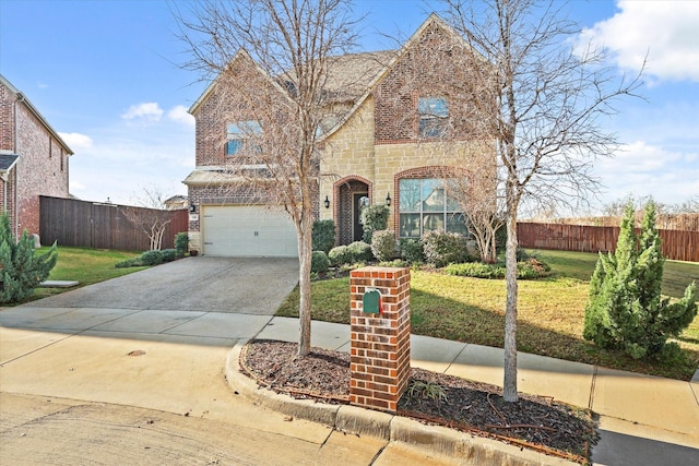 tudor-style house with a front yard and a garage