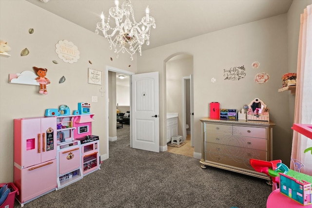 recreation room with carpet and an inviting chandelier