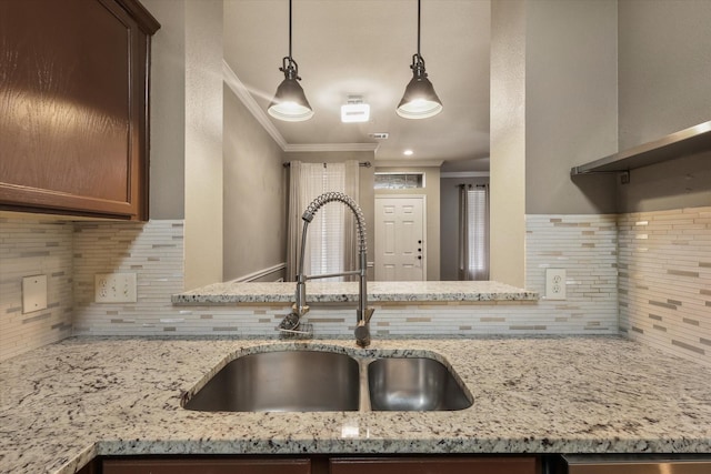2204 Stonepark Pl, Mckinney, TX 75071 - kitchen featuring crown molding, a sink, decorative backsplash, and light stone counters