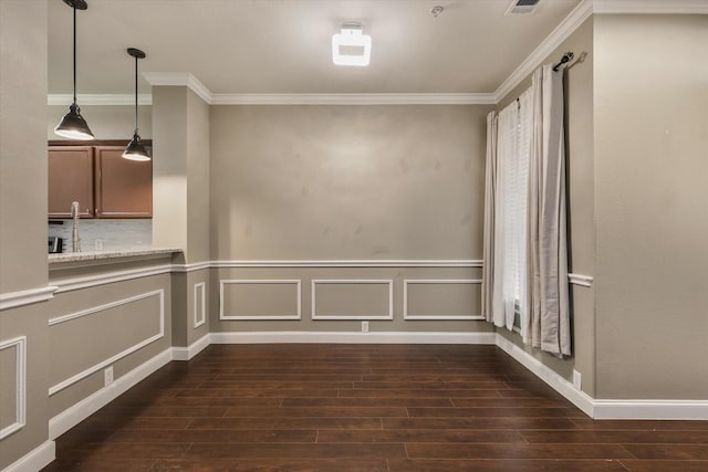 2204 Stonepark Pl, Mckinney, TX 75071 - unfurnished dining area featuring dark wood-type flooring, ornamental molding, and wainscoting