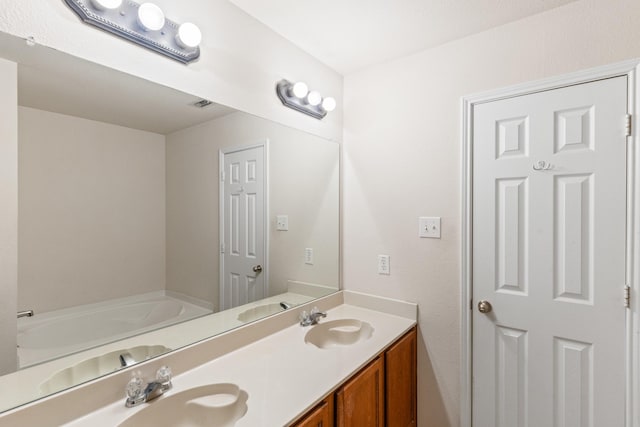 bathroom featuring a bath and vanity