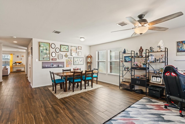 dining area with ceiling fan and dark hardwood / wood-style flooring