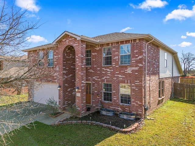 view of front of house featuring a garage and a front lawn