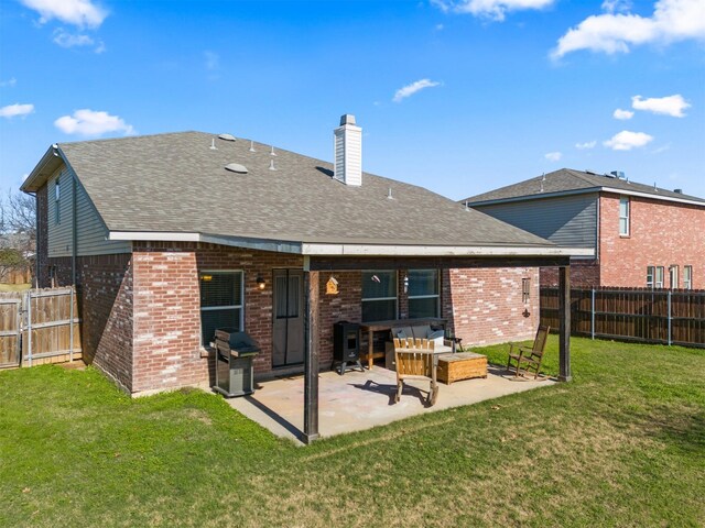 back of property featuring a lawn, a patio area, and an outdoor hangout area