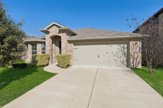 view of front of home with a garage and a front lawn