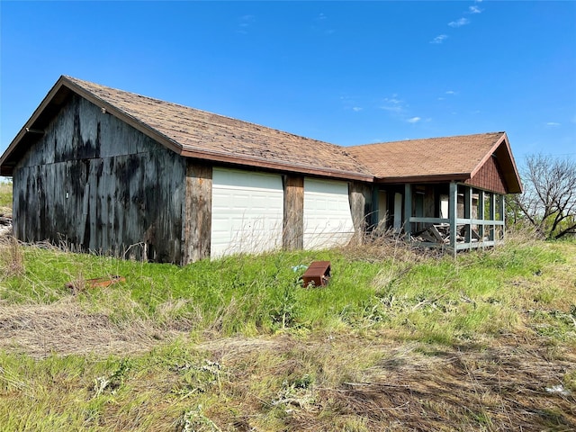 view of front of property featuring a garage and an outdoor structure