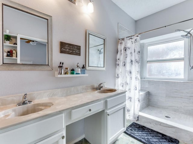 bathroom featuring vanity and curtained shower