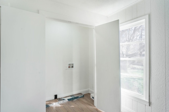 laundry area featuring washer hookup and light hardwood / wood-style floors