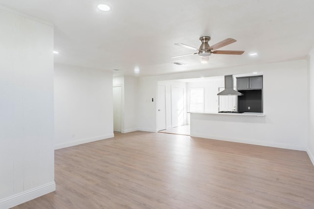 unfurnished living room with ceiling fan and light hardwood / wood-style floors