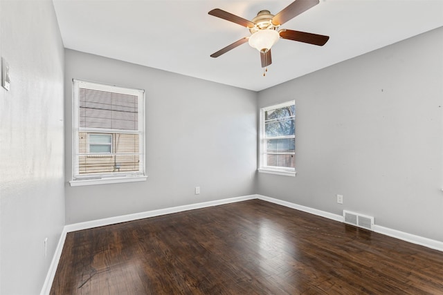 spare room with ceiling fan and dark hardwood / wood-style floors