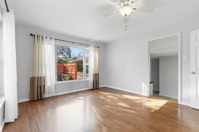 unfurnished room featuring hardwood / wood-style floors and ceiling fan