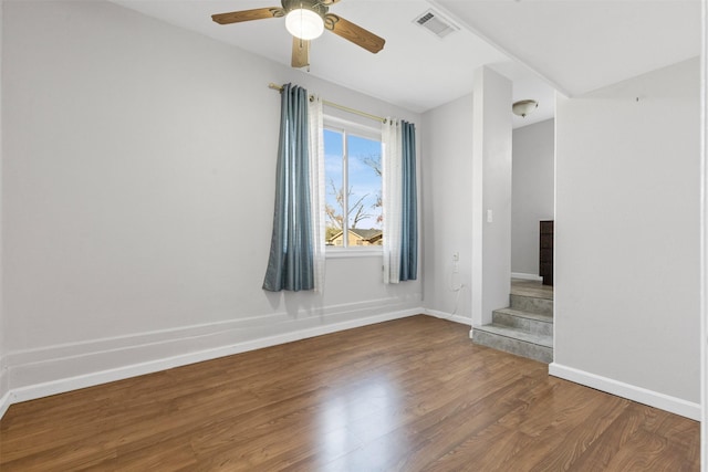 spare room with wood-type flooring and ceiling fan