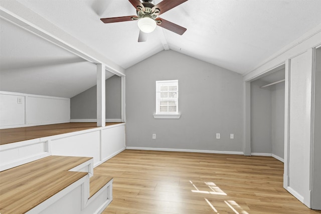 bonus room with ceiling fan, lofted ceiling, and light wood-type flooring