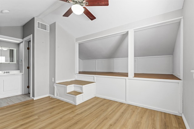 bonus room with lofted ceiling, light hardwood / wood-style flooring, and ceiling fan