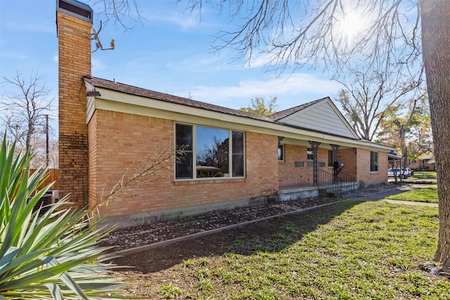 view of side of home featuring a lawn