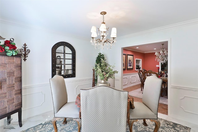 dining area with an inviting chandelier and crown molding