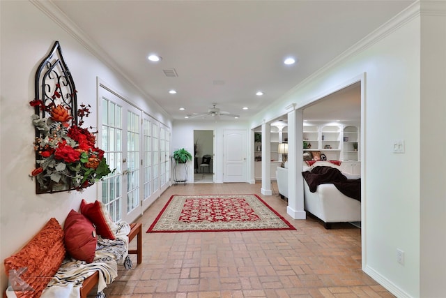 corridor featuring built in features and ornamental molding