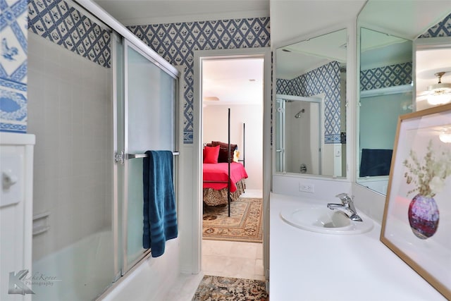 bathroom with shower / bath combination with glass door and vanity