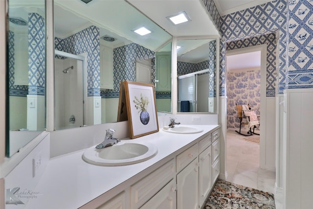 bathroom featuring vanity and a shower with door