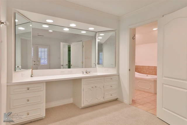 bathroom featuring tile patterned floors, vanity, a bathtub, and crown molding