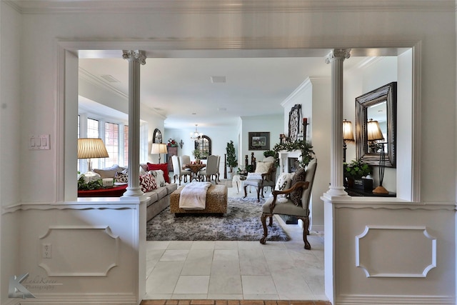 living room with ornate columns and crown molding