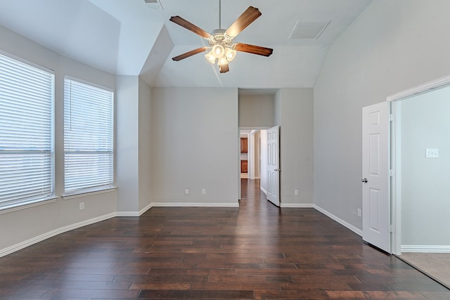 unfurnished room with ceiling fan, plenty of natural light, dark wood-type flooring, and vaulted ceiling