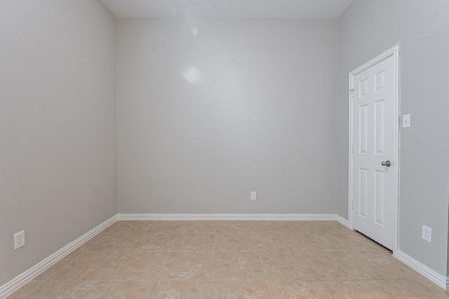 unfurnished room with light tile patterned flooring