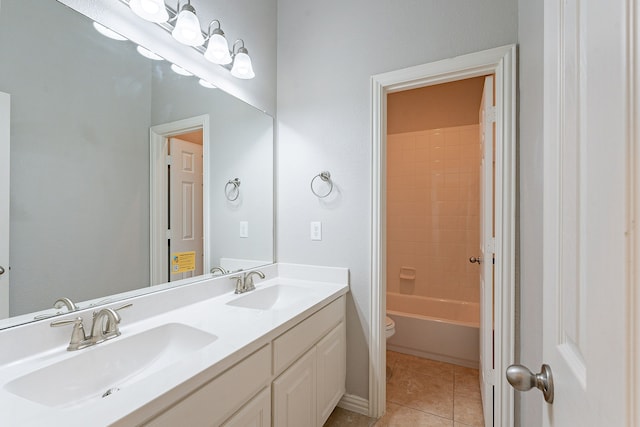 full bathroom with toilet, vanity, tile patterned floors, and tiled shower / bath combo