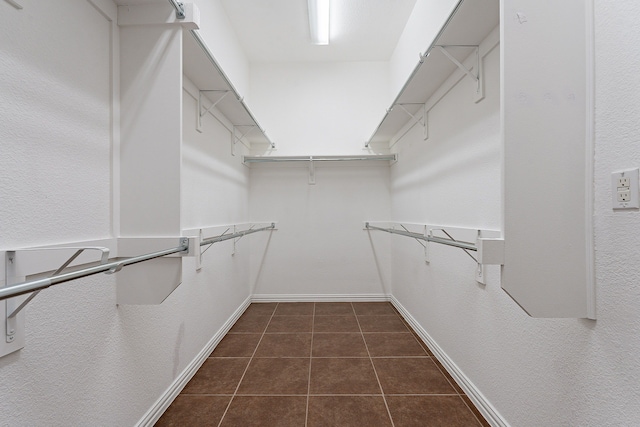 spacious closet featuring dark tile patterned floors