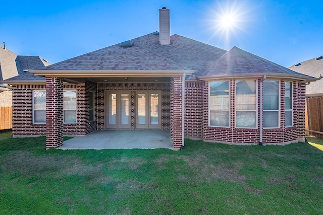 back of house featuring a patio and a lawn